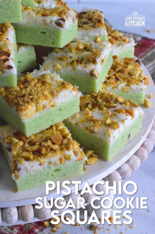 The uncomplicated and delicious sugar cookie gets a fresh, new flavour profile, and an upgrade in this Pistachio Sugar Cookie Squares recipe.  The classic sugar cookie base is pistachio flavoured and prepared with boxed pistachio pudding powder.  Topped with a layer of delicious buttercream frosting and sprinkled with roasted, salted chopped pistachios, this cookie is simply irresistible! #pistachio #sugarcookies #cookies #christmas #holiday #squares #baking