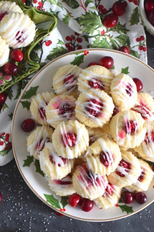 These mini, bite-sized Lemon Cranberry Cookies are prepared with a lightly sweetened vanilla cookie dough and topped with a sugary, sweet glaze.  Don't worry - the tartness of both the lemon and the cranberry can easily stand up to the sweetness! #lemoncranberry #cranberry #cranberries #cookies