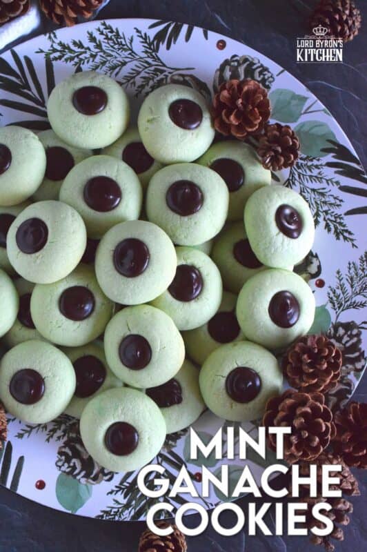 Mint Ganache Cookies are not only beautiful and tinted pastel green, they are deliciously flavoured with mint and topped with a silky, smooth, creamy mint ganache.  Unlike most ganache recipes, this one is prepared with butter, which keeps it shiny and velvety! #mint #ganache #thumbprint #christmascookies