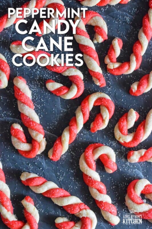 Peppermint Candy Cane Cookies are colourful, festive, and delicious!  Half of the buttery cookie dough is tinted with food colouring, twisted and formed into a classic candy cane shape.  Brushed with egg and topped with sanding sugar, these cookies are light and crisp and perfect for the holidays!  Just picture these on your Christmas cookie platters! #candycane #peppermint #cookies #christmas #holiday #baking