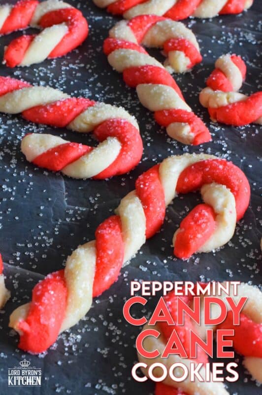 Peppermint Candy Cane Cookies are colourful, festive, and delicious!  Half of the buttery cookie dough is tinted with food colouring, twisted and formed into a classic candy cane shape.  Brushed with egg and topped with sanding sugar, these cookies are light and crisp and perfect for the holidays!  Just picture these on your Christmas cookie platters! #candycane #peppermint #cookies #christmas #holiday #baking