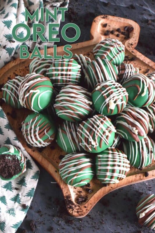 Otherwise known as truffles, these Mint Oreo Balls are prepared with crushed mint-flavoured Oreos and cream cheese.  They are dipped in melted green candy melts and drizzled with milk and white melted chocolate.  They're bright, beautiful, festive, and delicious! #oreo #truffles #balls #nobake #christmas