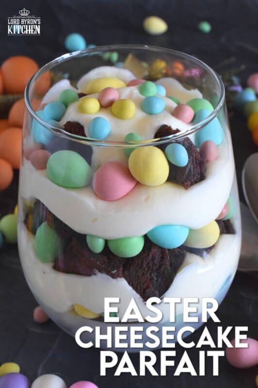 Crumbled brownies are layered with chocolate mini eggs and a homemade cream cheese filling in this Easter Cheesecake Parfait recipe.  Easily prepare everything a few days ahead of time and assemble the parfaits when ready to serve.  Make extra because these are deliciously addictive! #easter #dessert #parfait #brownie #minieggs