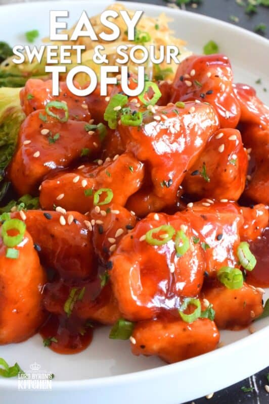 Extra firm tofu is seasoned and baked until lightly crispy on the outside with a slightly chewy, meatier inside.  It is then tossed in a homemade sweet and sour sauce which makes this one of the most delicious ways to enjoy a baked tofu dish!  If you think you don't like tofu, you obviously have not tried this recipe! #tofu #sweetandsour #meatless