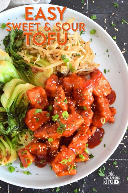 Extra firm tofu is seasoned and baked until lightly crispy on the outside with a slightly chewy, meatier inside.  It is then tossed in a homemade sweet and sour sauce which makes this one of the most delicious ways to enjoy a baked tofu dish!  If you think you don't like tofu, you obviously have not tried this recipe! #tofu #sweetandsour #meatless