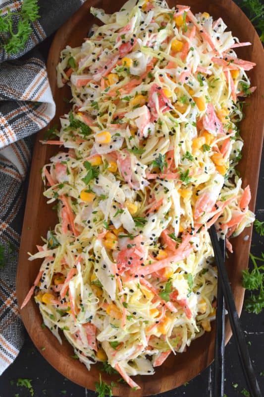 A popular side dish served with sushi, a Japanese Kani Side Salad is so delightfully refreshing, it should not be limited to just a sushi side!  Prepared with imitation crab, shredded cabbage, julienned carrots and corn in a creamy and zesty sauce, this salad is wonderfully easy and exceptionally delicious! #kani #salad #japanese #crab