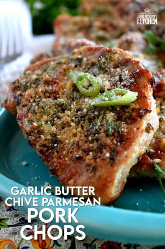 Using thin, boneless pork chops to keep the baking time quick, these chops are prepared with fresh garlic, salted butter, chopped chives, and freshly grated parmesan cheese.  They are so simple, yet deliciously impressive!  #porkchops #garlic #parmesan #fastfry