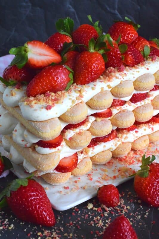 Locally grown strawberries are about to be in season which means it is time for a little indulgence!  Strawberry Shortcake Tiramisu is the most delicious summertime dessert.  With layers of homemade strawberry shortcake crumbs, light and airy ladyfingers, and a thick, slightly sweet filling, this dessert is completely irresistible! #strawberry #shortcake #tiramisu