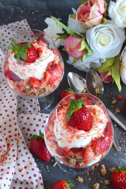 This beautifully presented dessert is exceptionally easy to prepare.  Layered with granola, yogurt, and fresh strawberries, is a homemade strawberry shortcake crumb mixture that is the star of this simply refreshing summertime dessert.  It's a healthy alternative with just the right amount of indulgence! #strawberries #shortcake #parfait #crumbs