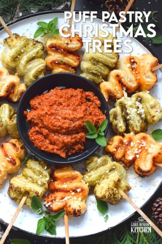 This light and airy appetizer is prepared with store-bought sheets of frozen puff pastry and your favourite sun-dried tomato or basil pesto.  They're so quick and easy to prepare - anyone can do this!  Serve with a side of warm marinara sauce for best results. #holilday #christmas #appetizer #puffpastry #pesto