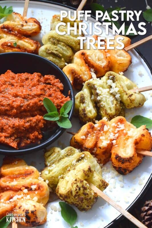 This light and airy appetizer is prepared with store-bought sheets of frozen puff pastry and your favourite sun-dried tomato or basil pesto.  They're so quick and easy to prepare - anyone can do this!  Serve with a side of warm marinara sauce for best results. #holilday #christmas #appetizer #puffpastry #pesto