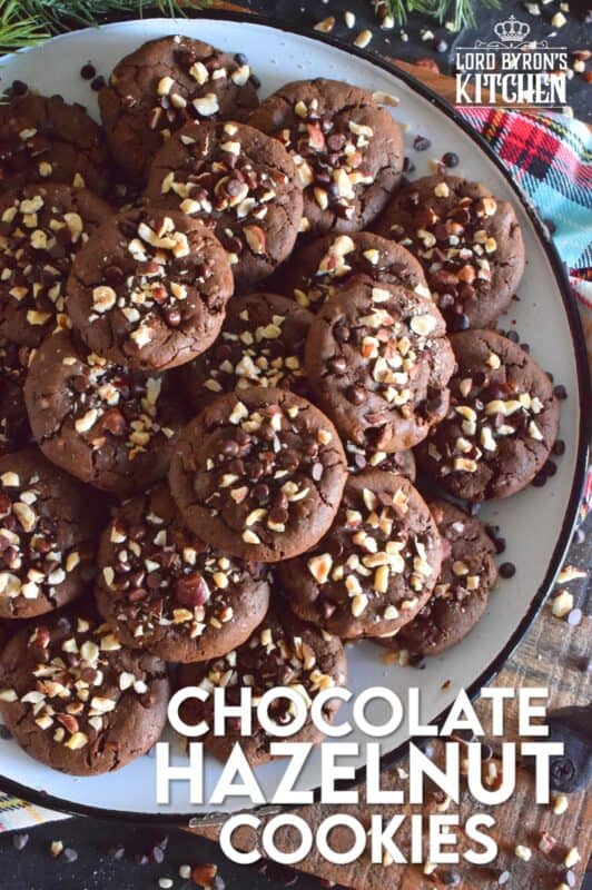 These cookies are slightly crispy on the outside, but with a moist and dense chocolaty center. Loaded with lots of chocolate chips and hazelnuts, Chocolate Hazelnut Cookies taste very much like eating a big spoon of Nutella in cookie form! #chocolatecookies #hazelnut #christmas #holiday #baking