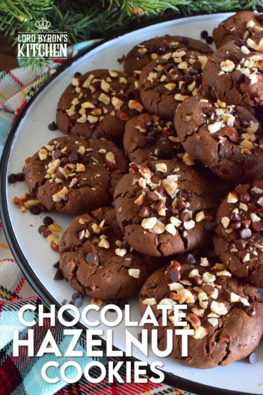 These cookies are slightly crispy on the outside, but with a moist and dense chocolaty center. Loaded with lots of chocolate chips and hazelnuts, Chocolate Hazelnut Cookies taste very much like eating a big spoon of Nutella in cookie form! #chocolatecookies #hazelnut #christmas #holiday #baking