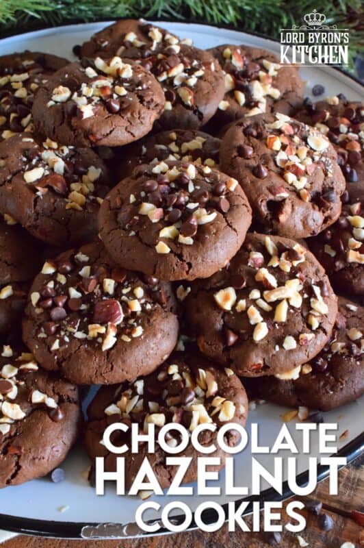 These cookies are slightly crispy on the outside, but with a moist and dense chocolaty center. Loaded with lots of chocolate chips and hazelnuts, Chocolate Hazelnut Cookies taste very much like eating a big spoon of Nutella in cookie form! #chocolatecookies #hazelnut #christmas #holiday #baking