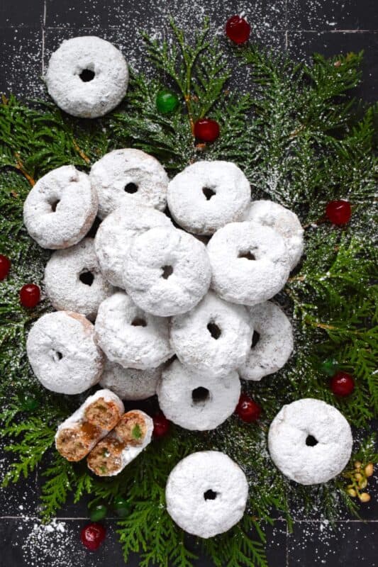 Packed full of red and green candied cherries and chopped toasted walnuts, these Walnut Cherry Donuts are the epitome of holiday-themed donuts!  Baked with familiar Christmas spices, this donut is very similar in flavour to fruitcake - but without the fuss! #walnut #candied #cherries #donuts