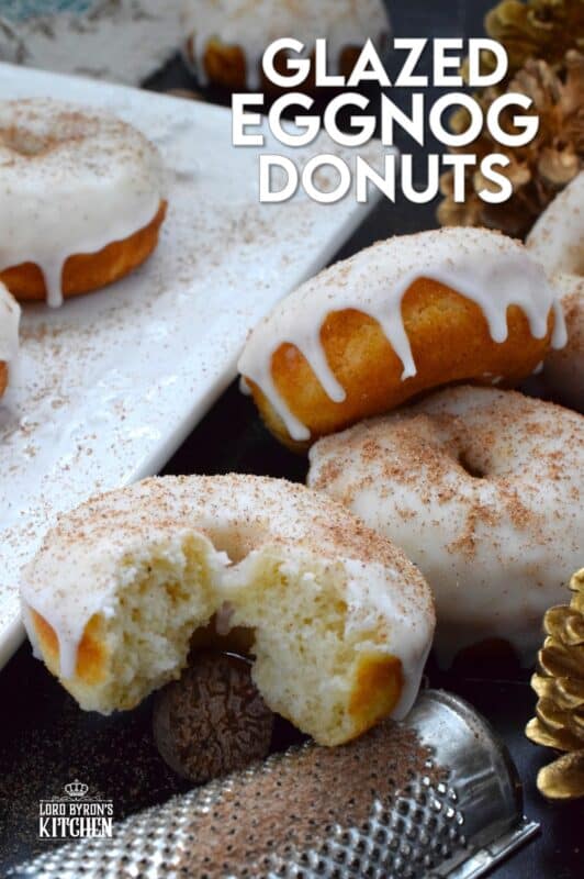 These Glazed Eggnog Donuts are baked and not fried, which means they are super light and fluffy.  Eggnog is baked right into the batter and the glaze is made with eggnog too, ensuring that this donut lives up to its name!  Optionally, this recipe permits a splash or rum or an alcohol-free version too! #donuts #doughnuts #eggnog #christmas #baked