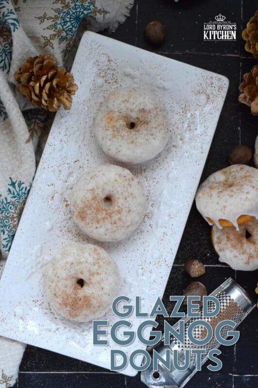 These Glazed Eggnog Donuts are baked and not fried, which means they are super light and fluffy.  Eggnog is baked right into the batter and the glaze is made with eggnog too, ensuring that this donut lives up to its name!  Optionally, this recipe permits a splash or rum or an alcohol-free version too! #donuts #doughnuts #eggnog #christmas #baked