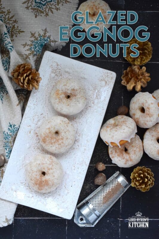 These Glazed Eggnog Donuts are baked and not fried, which means they are super light and fluffy.  Eggnog is baked right into the batter and the glaze is made with eggnog too, ensuring that this donut lives up to its name!  Optionally, this recipe permits a splash or rum or an alcohol-free version too! #donuts #doughnuts #eggnog #christmas #baked