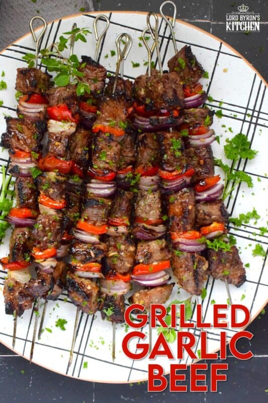 Marinated and skewered, Grilled Garlic Beef is simple and easy to prepare, but the flavour is extraordinary!  The quick-to-prepare marinade is loaded with garlic which both permeates the beef and tenderizes it too.  The addition of the onions and sweet bell peppers round out the flavour. #beef #garlic #garlicky #grill #bbq