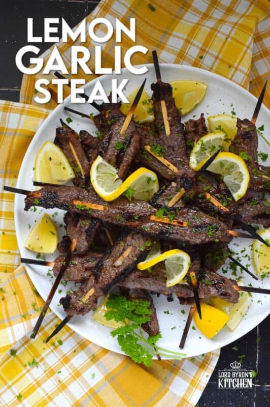 Thin slices of beef are marinated with fresh lemon juice, chopped garlic, and seasonings before being skewered and grilled to perfection!  Be sure to serve this Lemon Garlic Steak with lots of fresh lemons for extra zip and zing! #steak #grilled #garlic #lemon