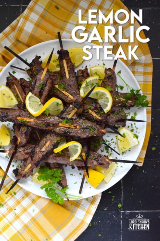 Thin slices of beef are marinated with fresh lemon juice, chopped garlic, and seasonings before being skewered and grilled to perfection!  Be sure to serve this Lemon Garlic Steak with lots of fresh lemons for extra zip and zing! #steak #grilled #garlic #lemon