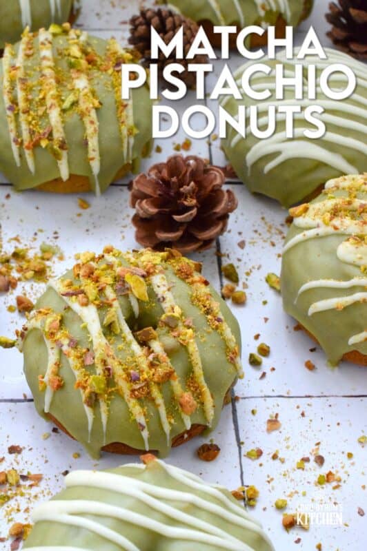 Everything is coming up green in these Matcha Pistachio Donuts!  The batter is light and fluffy and prepared with finely chopped pistachios and matcha.  Dipped in matcha-infused icing and drizzled with white chocolate, these donuts are delicious and addictive! #matcha #greentea #donuts #pistachio