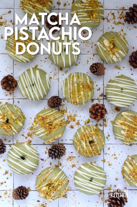 Everything is coming up green in these Matcha Pistachio Donuts!  The batter is light and fluffy and prepared with finely chopped pistachios and matcha.  Dipped in matcha-infused icing and drizzled with white chocolate, these donuts are delicious and addictive! #matcha #greentea #donuts #pistachio