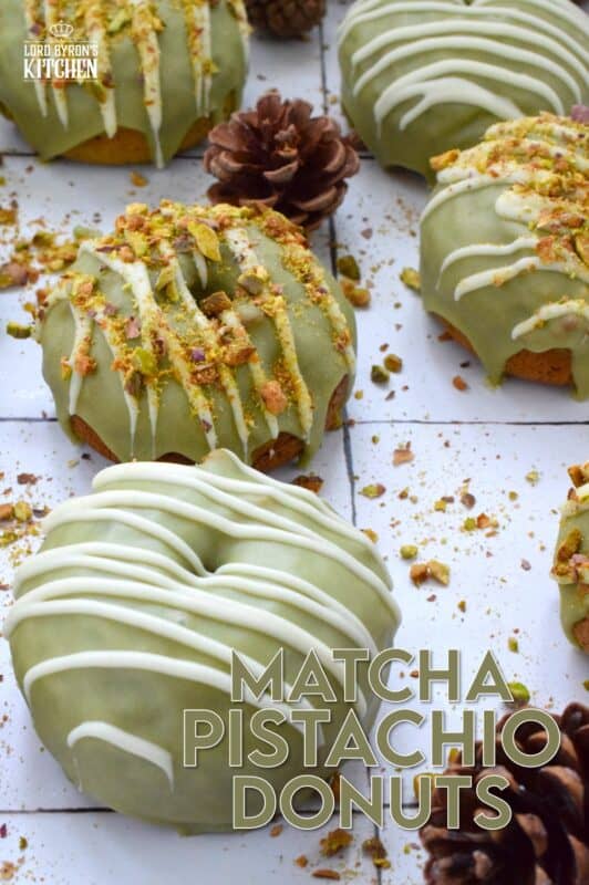 Everything is coming up green in these Matcha Pistachio Donuts!  The batter is light and fluffy and prepared with finely chopped pistachios and matcha.  Dipped in matcha-infused icing and drizzled with white chocolate, these donuts are delicious and addictive! #matcha #greentea #donuts #pistachio