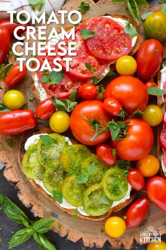 Summer fresh tomatoes are piled onto lightly toasted bread with a generous spread made with cream cheese.  Tomato Cream Cheese Toast is a delicious summertime lunch or an appetizer too!  Don't forget to season the tomatoes well and use fresh herbs for flavour and garnish. #sandwich #tomato #openfaced #creamcheese