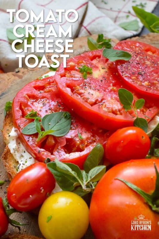 Summer fresh tomatoes are piled onto lightly toasted bread with a generous spread made with cream cheese.  Tomato Cream Cheese Toast is a delicious summertime lunch or an appetizer too!  Don't forget to season the tomatoes well and use fresh herbs for flavour and garnish. #sandwich #tomato #openfaced #creamcheese