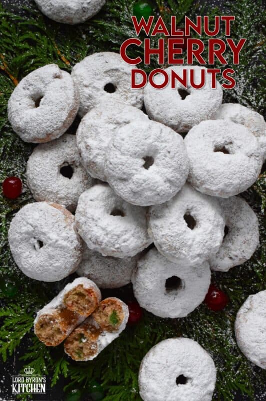 Packed full of red and green candied cherries and chopped toasted walnuts, these Walnut Cherry Donuts are the epitome of holiday-themed donuts!  Baked with familiar Christmas spices, this donut is very similar in flavour to fruitcake - but without the fuss! #walnut #candied #cherries #donuts
