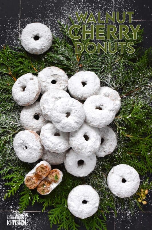 Packed full of red and green candied cherries and chopped toasted walnuts, these Walnut Cherry Donuts are the epitome of holiday-themed donuts!  Baked with familiar Christmas spices, this donut is very similar in flavour to fruitcake - but without the fuss! #walnut #candied #cherries #donuts