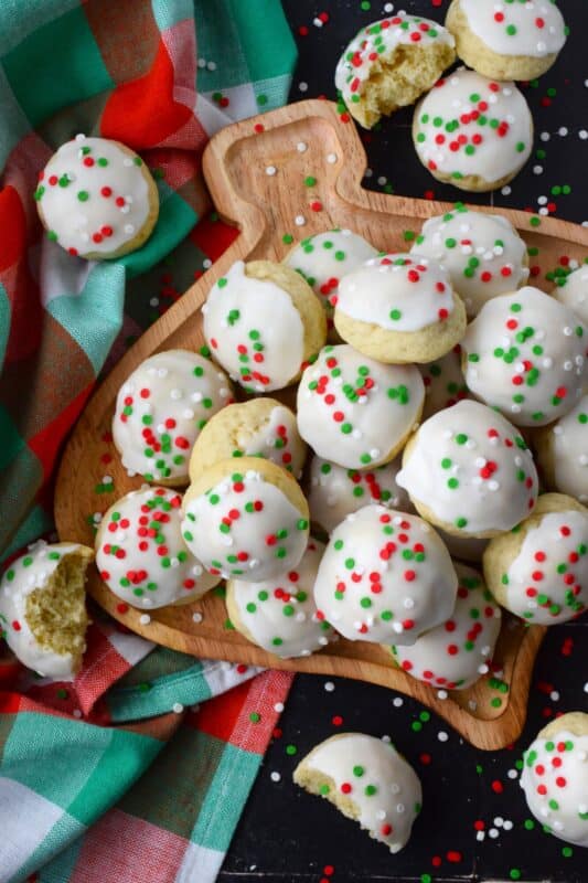 Italian Christmas Cookies just might be one of the most sought-after holiday cookies ever - right after shortbread!  These soft, moist, and sweet cookies are prepared with salted butter and ricotta cheese.  You just know that if those two ingredients are in anything, it's going to be delicious! Topped with icing and sprinkles, these just scream Christmas! #italian #cookies #ricotta