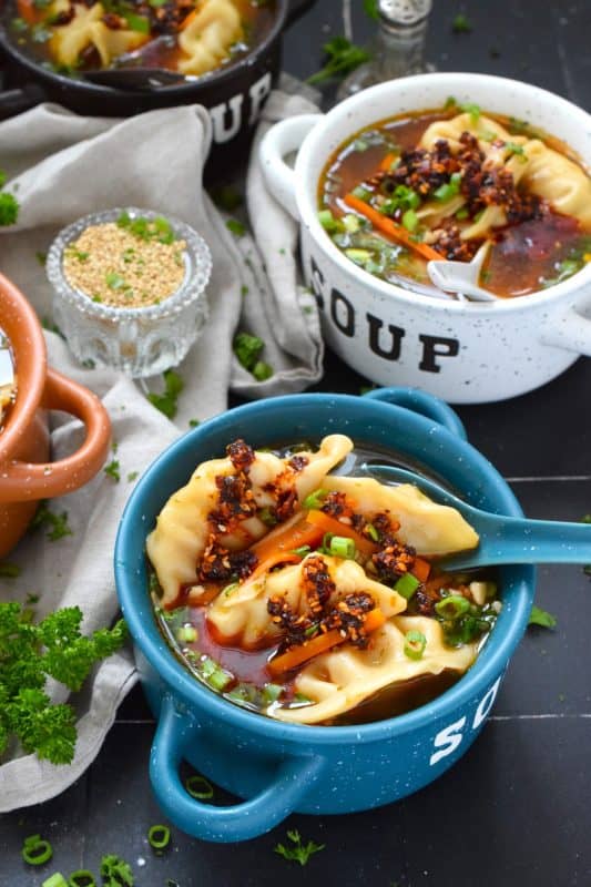 Pick up a package of frozen potstickers, wontons, or dumplings from your local grocery store and cook them in a savoury broth to make the most deliciously wonderful Spicy Potsticker Soup.  Loaded with green onions, garlic, ginger, and carrots, this soup is good for you too! #spicy #potsticker #wonton #gyoza #stew #soup #chili #chilicrunch