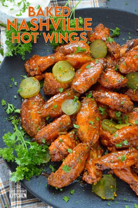 Baked to perfection with a crispy coating and a tender and juicy interior, these wings are drenched in a hot sauce comprised of cayenne, chili, garlic, onion, and melted butter, Baked Nashville Hot Wings also have an optionally sweet honey component!  Plate these wings with sweet pickle slices for a cooling crunch! #baked #nashville #hot #chicken #wings #sticky