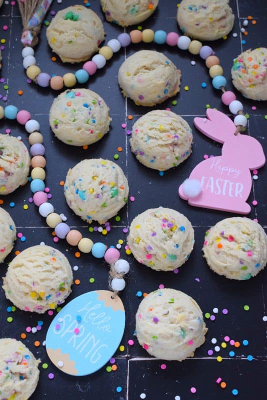 There is no better time to bake a cookie that is packed with sprinkles and chocolates than Easter!  This Easter Condensed Milk Cookie is very easy to make and requires only five common pantry ingredients in addition to the sprinkles and chocolate.  They are puffy, light, airy, and delicious! #easter #cookies #cadbury #minieggs #chocolate #sprinkles