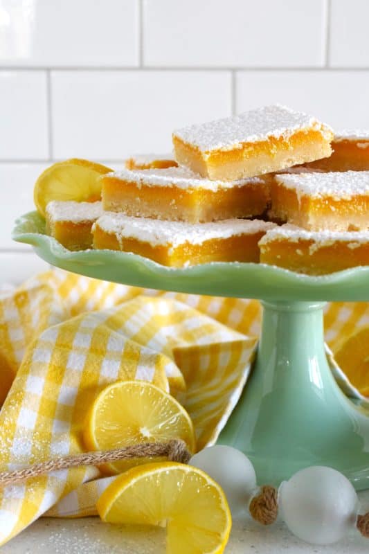 Pucker up! These Lemon Shortbread Bars are perfectly balanced with tartness from the lemons and sweetness from the sugar. The easy to prepare lemon filling is baked right on top of that homemade buttery shortbread crust. Perfect to serve at Easter brunch, a light and refreshing summer dessert, but so delicious you can whip up a batch of these for any occasion! #lemon #bars #shortbread #easter #squares