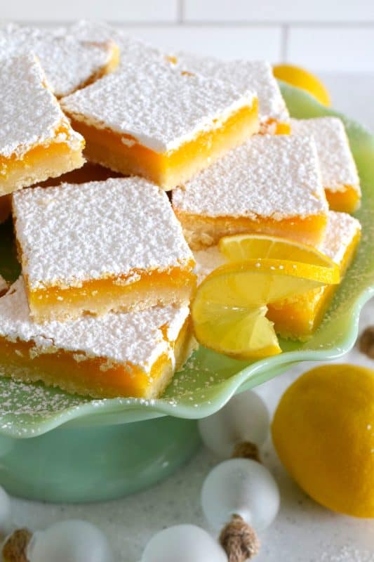 Pucker up! These Lemon Shortbread Bars are perfectly balanced with tartness from the lemons and sweetness from the sugar. The easy to prepare lemon filling is baked right on top of that homemade buttery shortbread crust. Perfect to serve at Easter brunch, a light and refreshing summer dessert, but so delicious you can whip up a batch of these for any occasion! #lemon #bars #shortbread #easter #squares