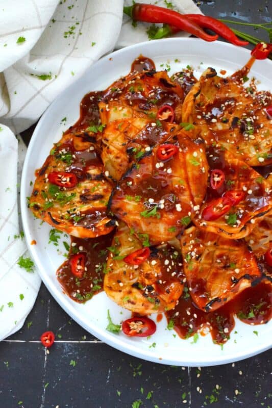 Any excuse to grill is a good excuse! This recipe makes use of a homemade sauce consisting of garlic, ginger, soy sauce, red chilies, and hot sauce. Grilled Hot and Spicy Squid is quick and easy; the squid is super tender with a few char marks. Use freshly prepared squid or frozen squid tubes here! #squid #grilled #hot #spicy #calamari #tubes