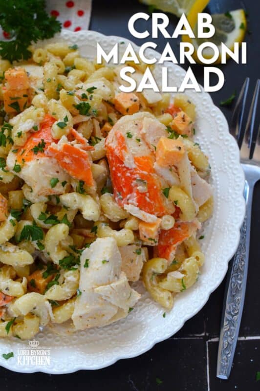 Flaked crab is tossed with cooked macaroni, dill pickles, and cheese in this Crab Macaroni Salad. The dressing is both creamy and tangy and is prepared with mayonnaise, vinegar, mustard, and old bay seasoning. This make-ahead salad is great for backyard barbecues and picnics! #salad #macaroni #seafood #crab #imitation