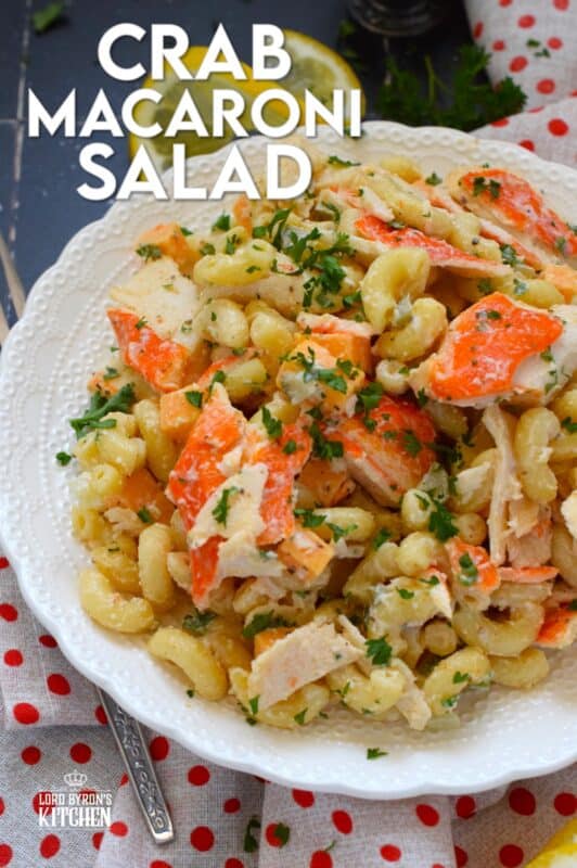 Flaked crab is tossed with cooked macaroni, dill pickles, and cheese in this Crab Macaroni Salad. The dressing is both creamy and tangy and is prepared with mayonnaise, vinegar, mustard, and old bay seasoning. This make-ahead salad is great for backyard barbecues and picnics! #salad #macaroni #seafood #crab #imitation