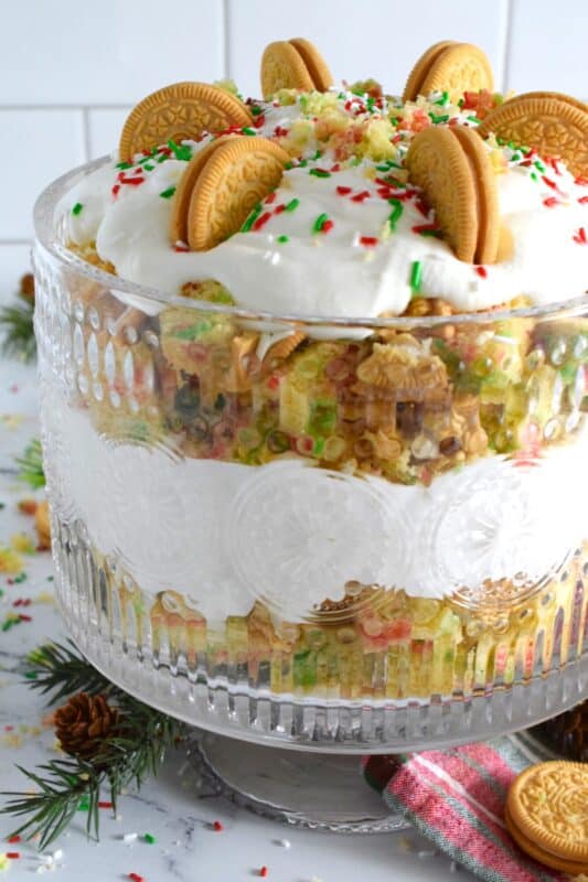 Starting with a homemade vanilla funfetti cake, this Funfetti Golden Oreo Trifle is layered with light and fluffy whipped cream, festive sprinkles, and crushed Oreo cookies. Put a smile on everyone's face with this deliciously gorgeous and easy Christmas dessert! #trifle #oreo #funfetti #sprinkles