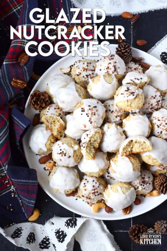 Alert the Mouse King because these Glazed Nutcracker Cookies are prepared with a copious amount of chopped nuts! Using salted nuts balances out the sweetness of the delicate, soft cookie and provides ample crunch and texture. Make extra and share them with your friends - just don't snack on them at the ballet! #nutcracker #christmas #cookies #glazed #nuts #nutty