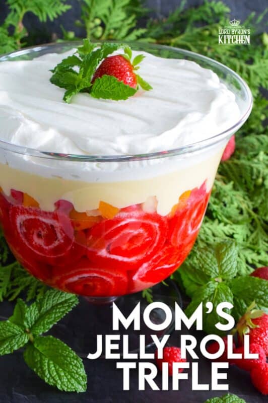 Mom's Jelly Roll Trifle starts with a store-bought raspberry jelly roll that is sliced and layered with raspberry jello, custard, fruit cocktail, and dream whip.  This uncomplicated dessert, with its humble beginnings, is how I remember my mom's deliciously satisfying Sunday trifle. #trifle #cocktail #jellyroll #dessert