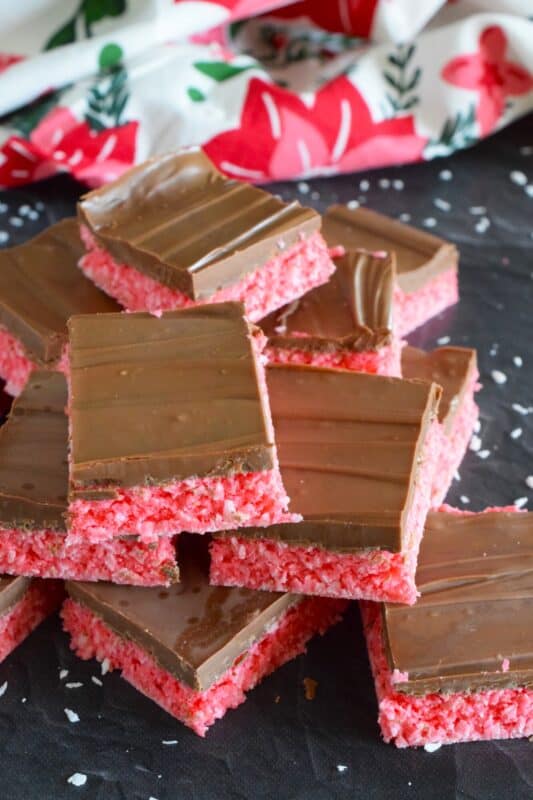 Holiday Ruffle Squares rely heavily on powdered jello mix for their flavour and colour. With only five ingredients, these squares are a no-bake confection that is easy to prepare and delicious to eat! Use any jello flavour you wish here; I'm using cherry to get that Christmasy red colour. #ruffle #nobake #squares #jello #christmas #bars #holiday