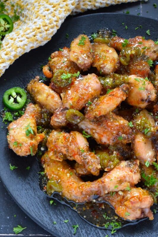 The wings are first baked to perfection with a crispy coating and a tender and juicy interior before being tossed in a thick, sweet, spicy, and sticky sauce. Sweet Jalapeno Wings are drenched in sauce, so be sure to have napkins close by! The combination of jalapenos with brown sugar, vinegar, and seasonings is simply wonderful! #chicken #wings #jalapeno #sticky #sweet #sauce