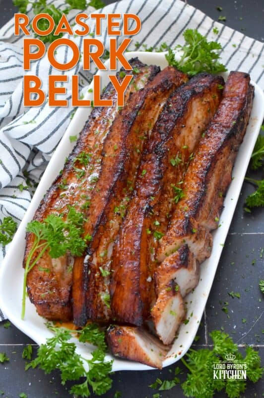 Roasted in a very hot oven, the thick skin on a slice of pork belly will develop a similar crispy and crunchy texture to that of chicharrones. Marinated and flavoured with simple seasonings and sauces found in most kitchens, this Roasted Pork Belly is baked until moist and tender, making this main easy to prepare and a delight to eat! #porkbelly #chicharrones #pork 