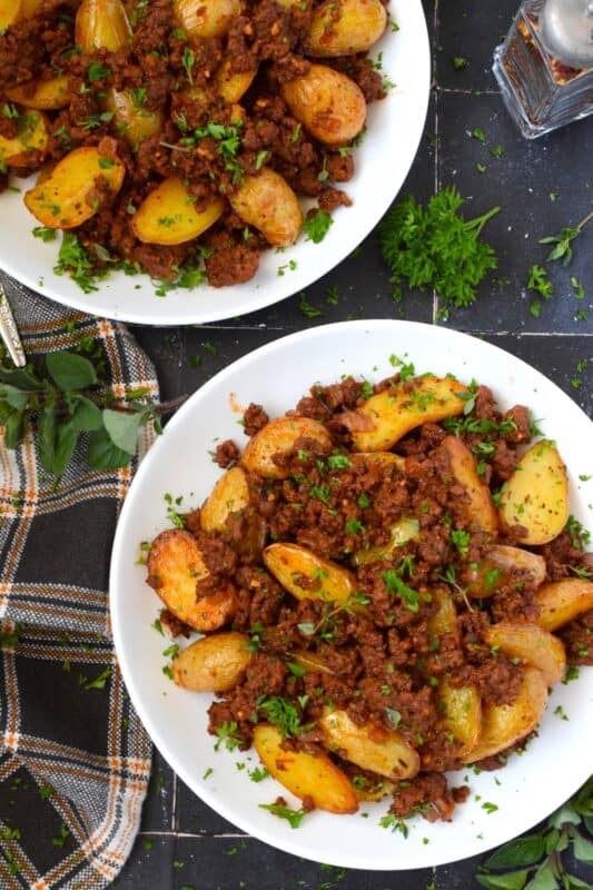 Perfectly seasoned and cooked ground beef is coupled with roasted baby potatoes.  This simple meat and potatoes dinner can be on the table in about 30 minutes or less!  Prepared with tomato paste and aromatics like garlic and onion, Roasted Potatoes and Ground Beef Dinner is an easy and delicious weeknight supper! #roastedpotatoes #groundbeef #dinner #meatandpotatoes