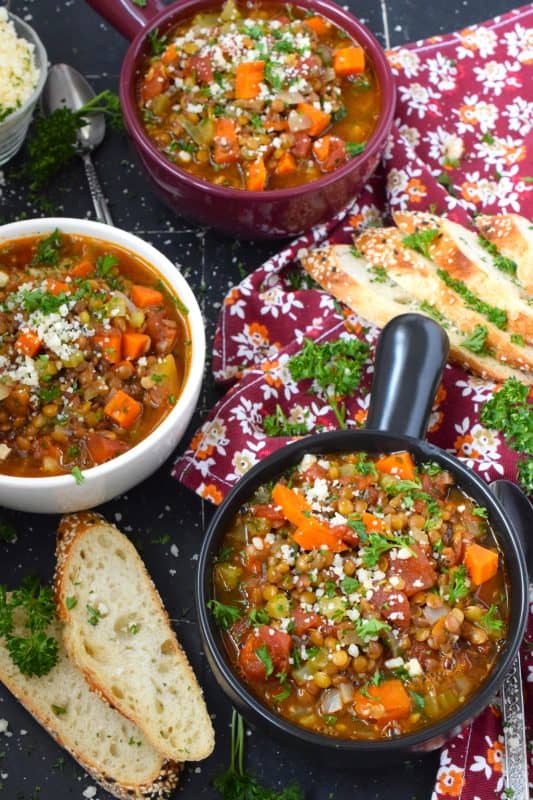 Italian Vegetable Lentil Soup is in fact more like a stew than a soup! It has a homestyle tomato flavour combined with the heartiness of tender, cooked lentils, and is paired with lots of fresh and good-for-you vegetables too. Top with grated parmesan and serve with crusty bread! #lentils #vegetable #soup #italian #parmesan