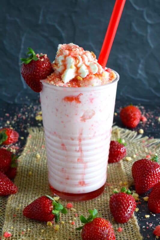 A frappuccino from Starbucks is one of my guilty pleasures, however, the rising cost of such pleasures has me learning how to make them at home for a fraction of the cost. This Strawberry Shortcake Frappuccino is prepared with homemade strawberry shortcake crumbs, milk, ice, vanilla extract, strawberry syrup, and whipped cream. It's even more delicious than it looks! #strawberry #shortcake #frappuccino #summer #frosty